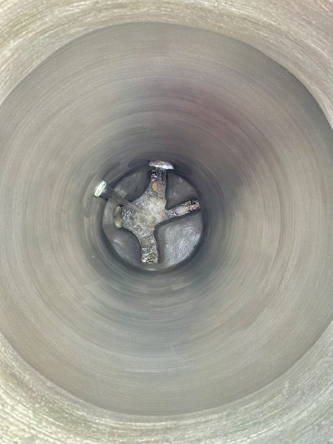 Manhole after CEI cementitious rehabilitation showing restored bench and invert